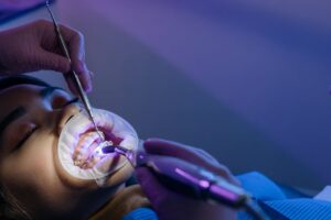 Orthodontist fitting dental types of braces