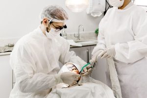 Dentist providing emergency dental care for a patient after trauma