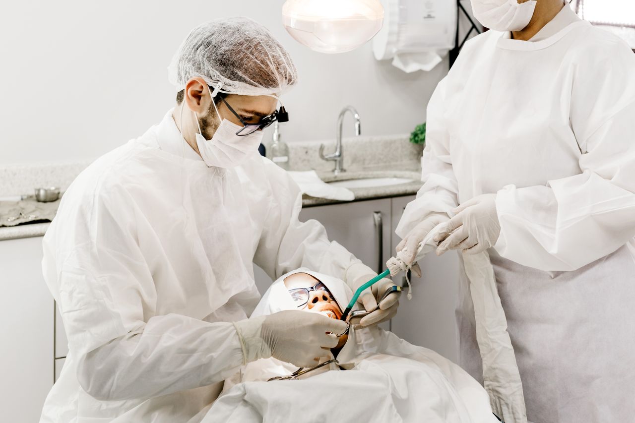 Dentist providing emergency dental care for a patient after trauma