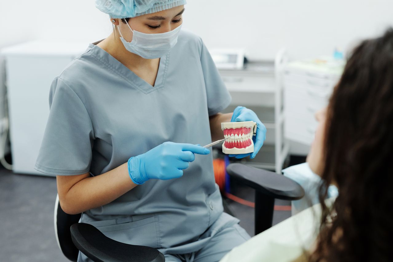 Dentist explaining tooth sensitivity treatment options to patient